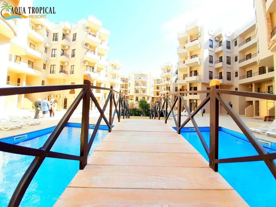 Aqua Tropical Resort — the timber bridge across the pool