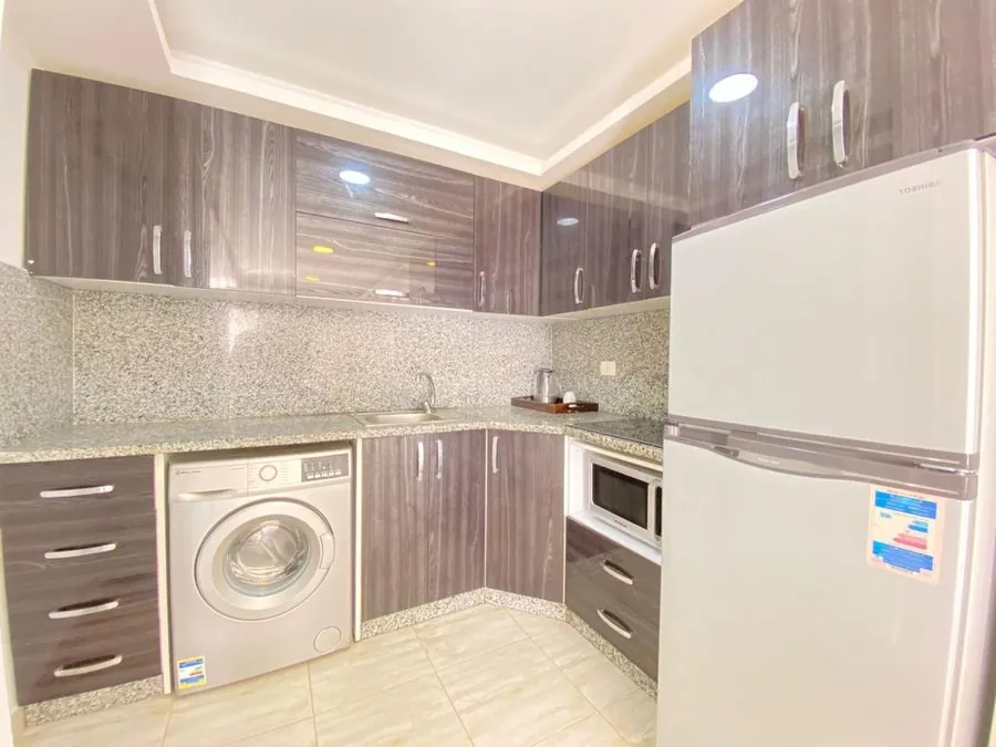 Penthouse at Aqua Palms — kitchen with washing machine